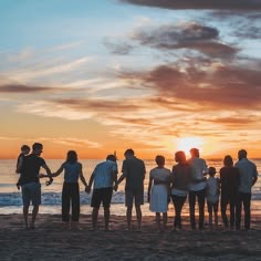 Friends enjoying a beautiful sunset on the beach